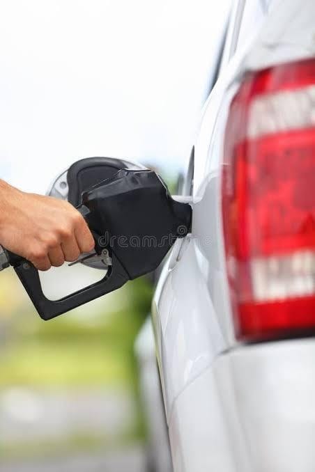 Person filling their car at a gas station — California has the highest gas taxes in the nation